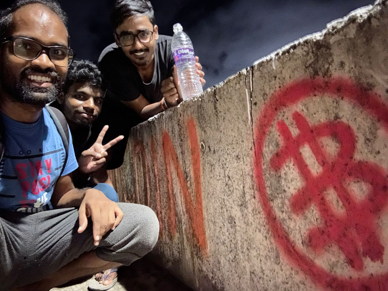 Hemath, Sai and Ragav looking at Bitcoin graffiti in Muttukadu bridge